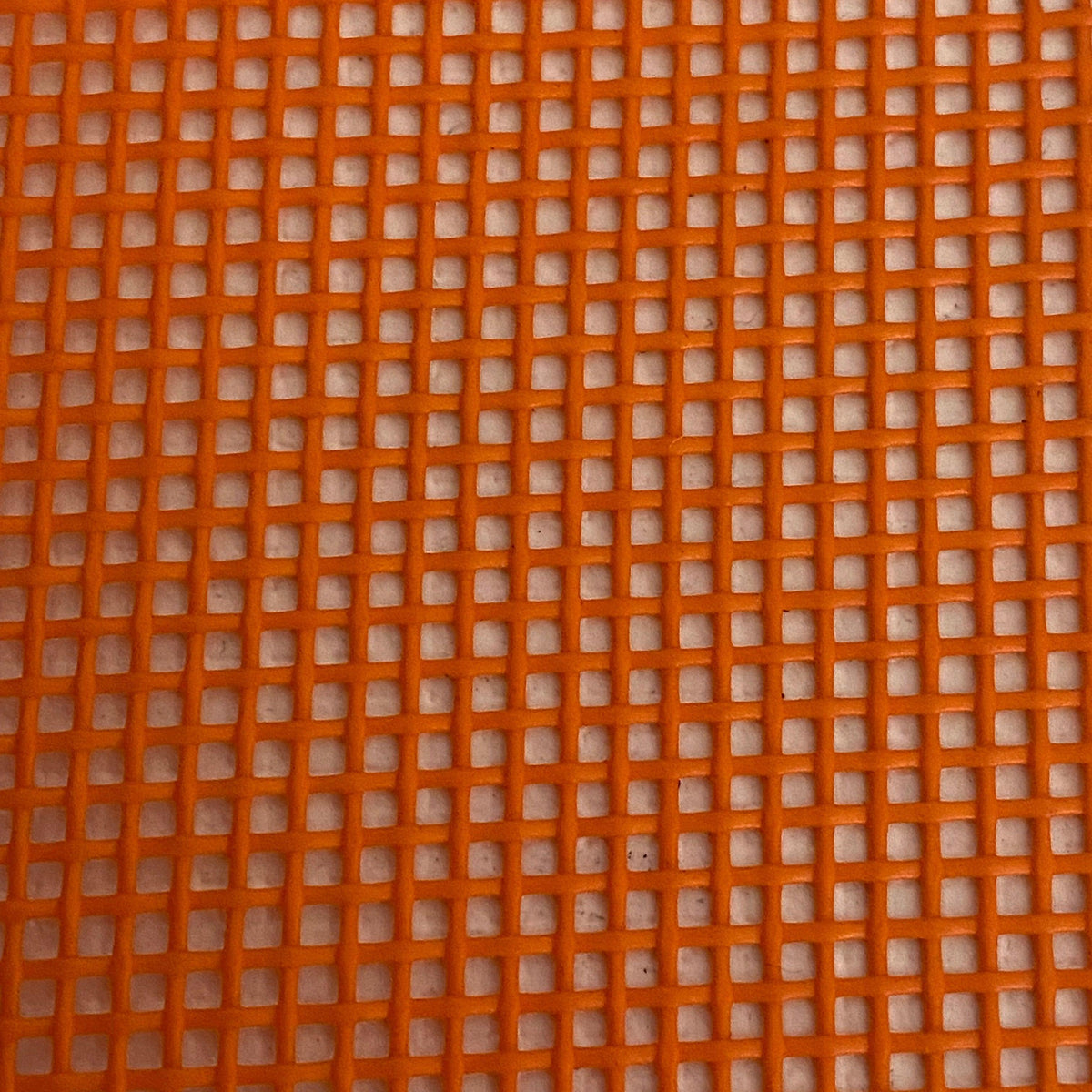 Close-up view of a heavy-duty orange mesh tarp made of UV-resistant polyester, featuring a pattern of square openings.