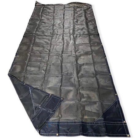 Top side of a black mesh tarp laid out on the floor showing the vinyl reinforced edges and even grommet spacing.