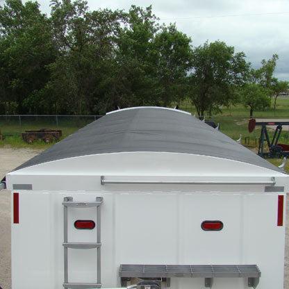 White trailer with a gray tarp on a cloudy day