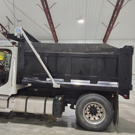 Dealer's customer's freightliner dump truck with a patriot aluminum electric tarping system installed on it.