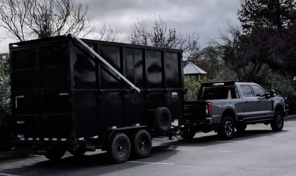 Customer provided photos of a aluminum electric tarping system installed on a modified dump trailer in California.