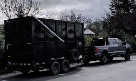 Customer provided photos of a aluminum electric tarping system installed on a modified dump trailer in California.