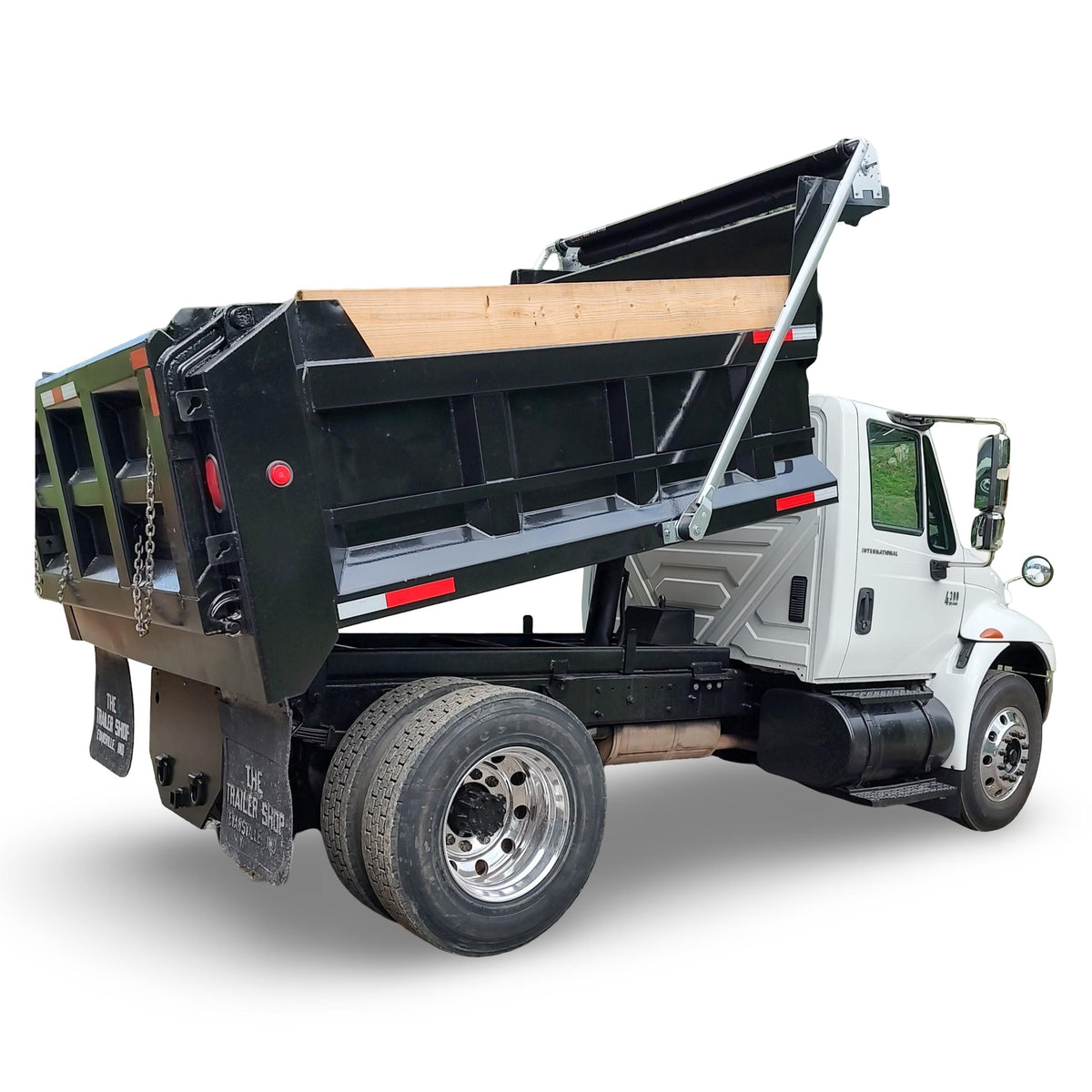Dump truck with an open bed on a white background with an aluminum electric tarp system installed on it.