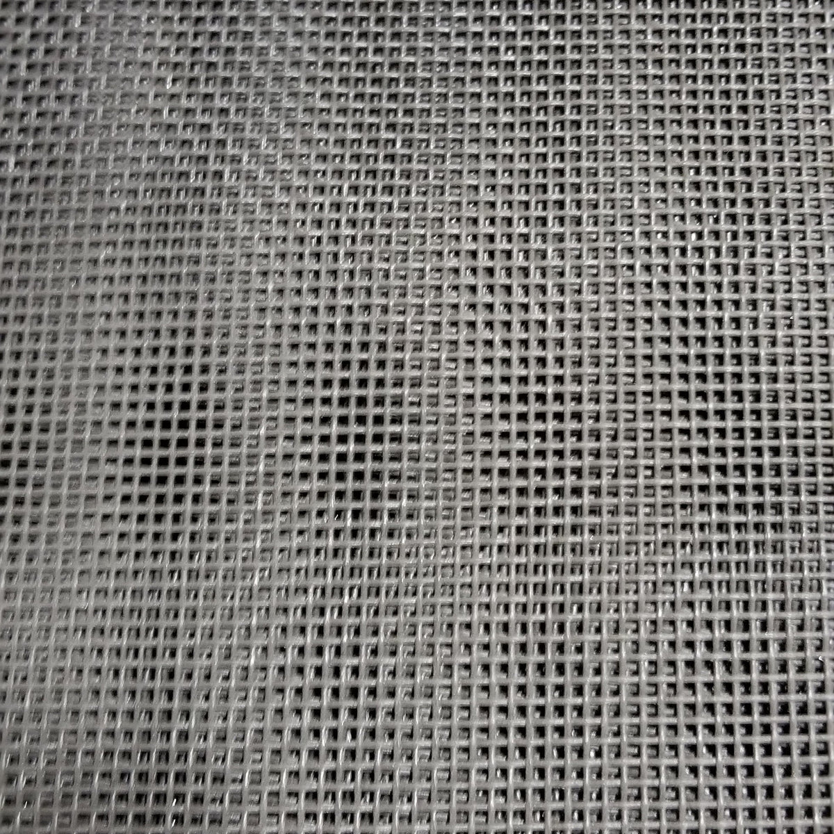 Close-up view of a black mesh dump truck tarp showing the weave pattern and texture.