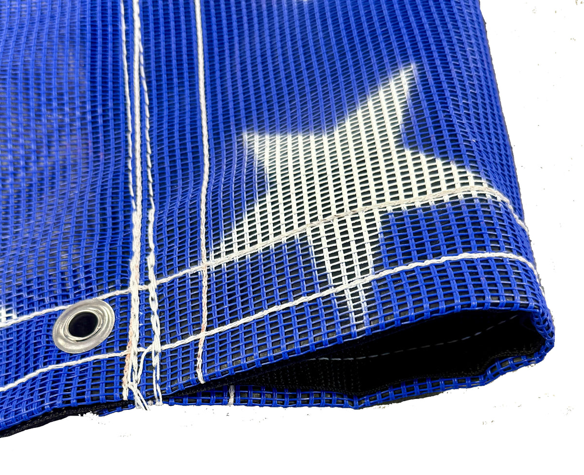 Blue American flag tarp displaying its white thread, grommets, and vinyl pocket reinforcement.