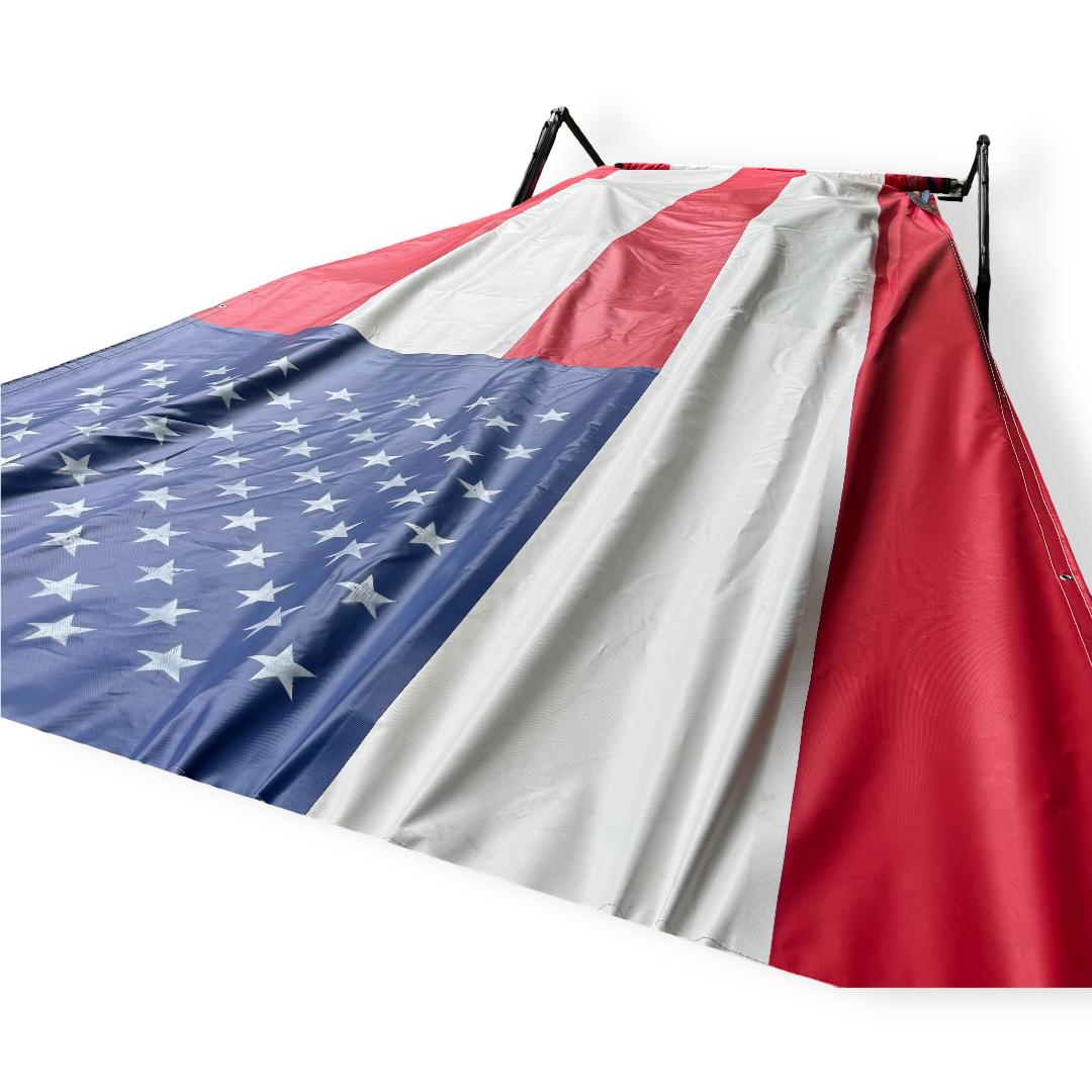 American flag tarp draped over a white surface with a neutral background