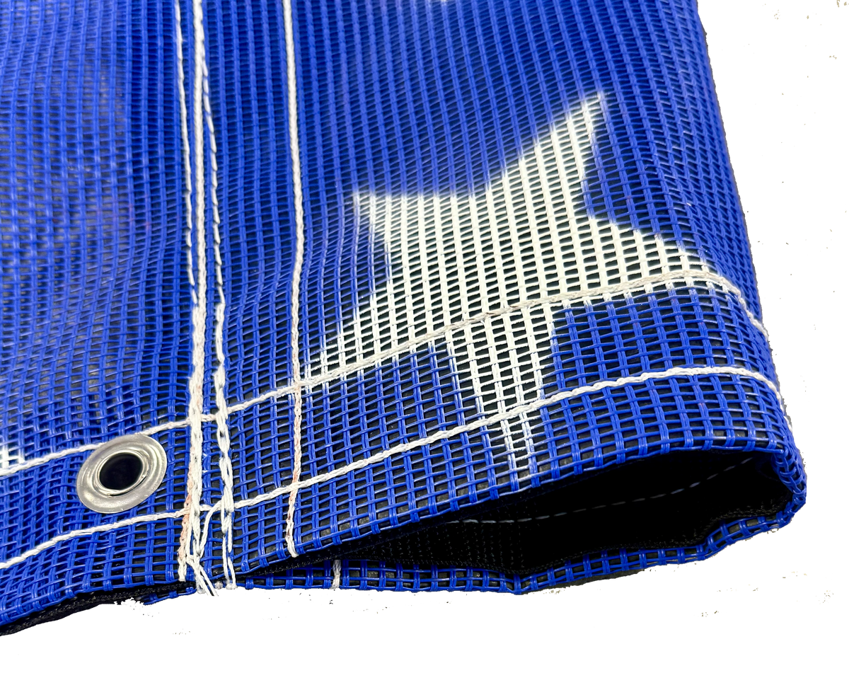 Blue American flag tarp displaying its white thread, grommets, and vinyl pocket reinforcement.
