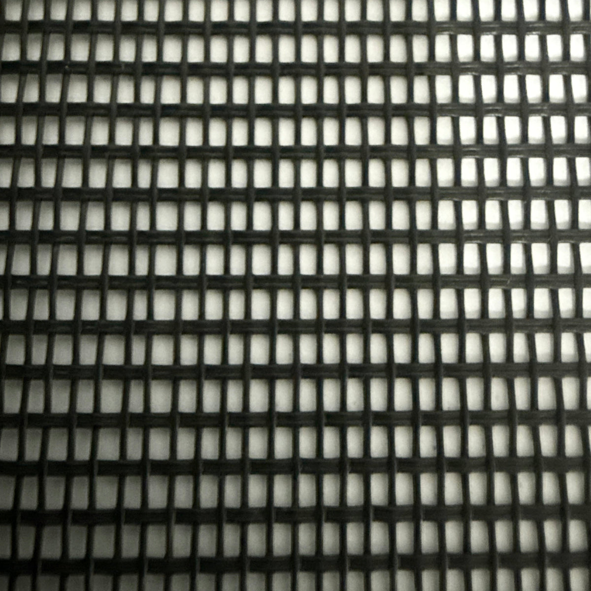Close-up of a black mesh material sample