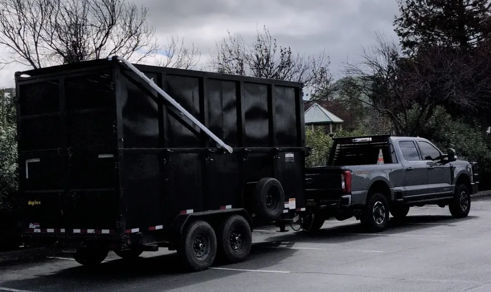 Customer provided photos of a aluminum electric tarping system installed on a modified dump trailer in California.