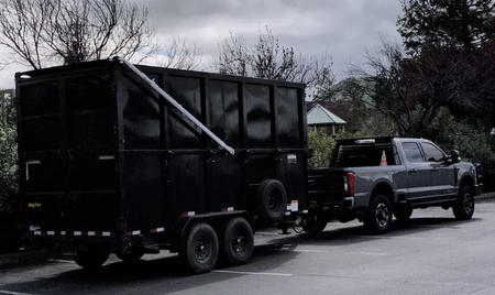 Customer provided photos of a aluminum electric tarping system installed on a modified dump trailer in California.
