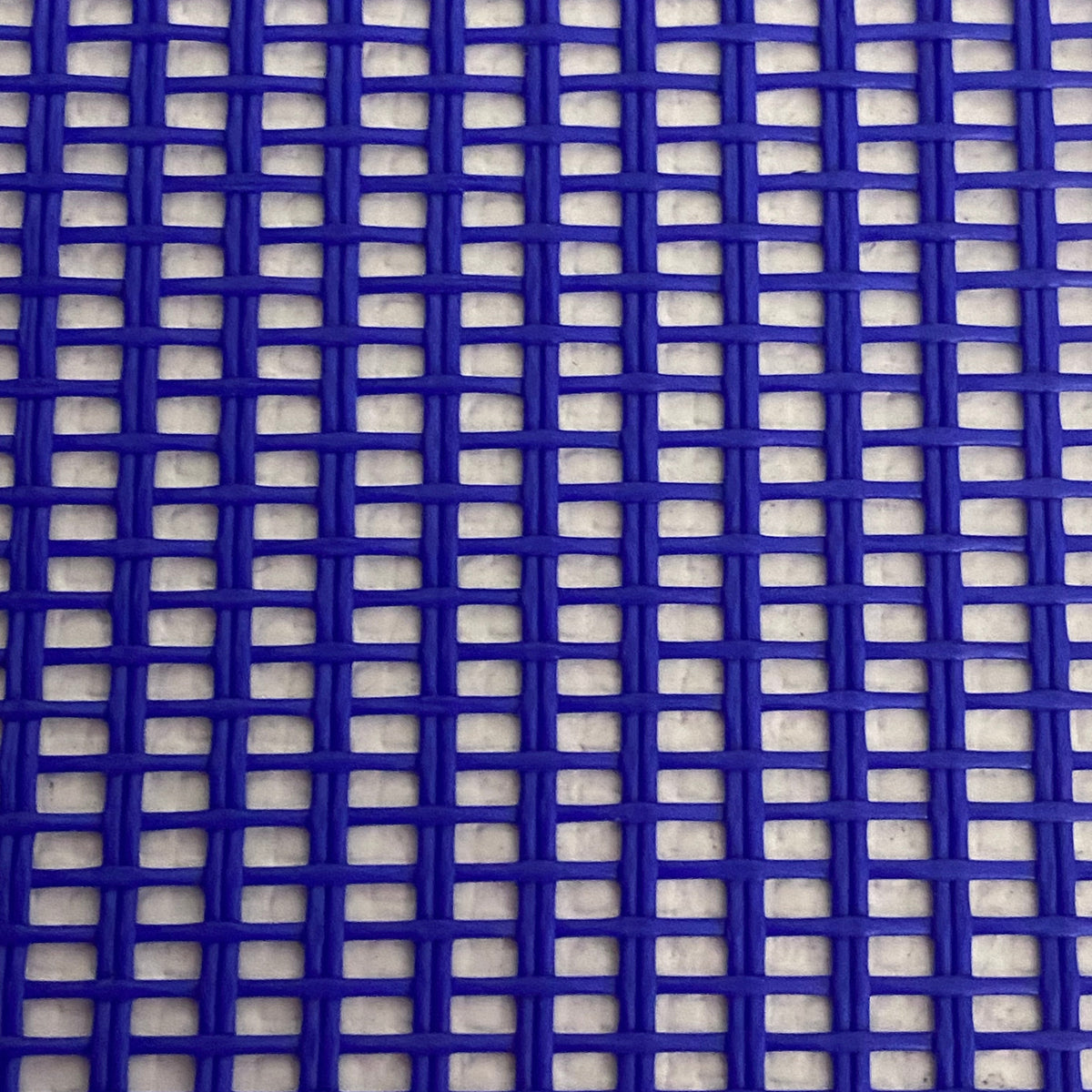 Close-up view of a heavy-duty blue mesh tarp made of UV-resistant polyester, featuring a pattern of square openings.