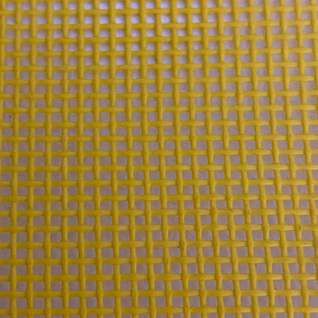 Close-up view of a heavy-duty yellow mesh tarp made of UV-resistant polyester, featuring a pattern of square openings.
