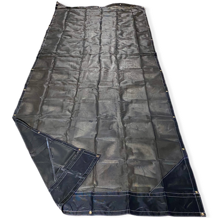 Top side of a black mesh tarp laid out on the floor showing the vinyl reinforced edges and even grommet spacing.