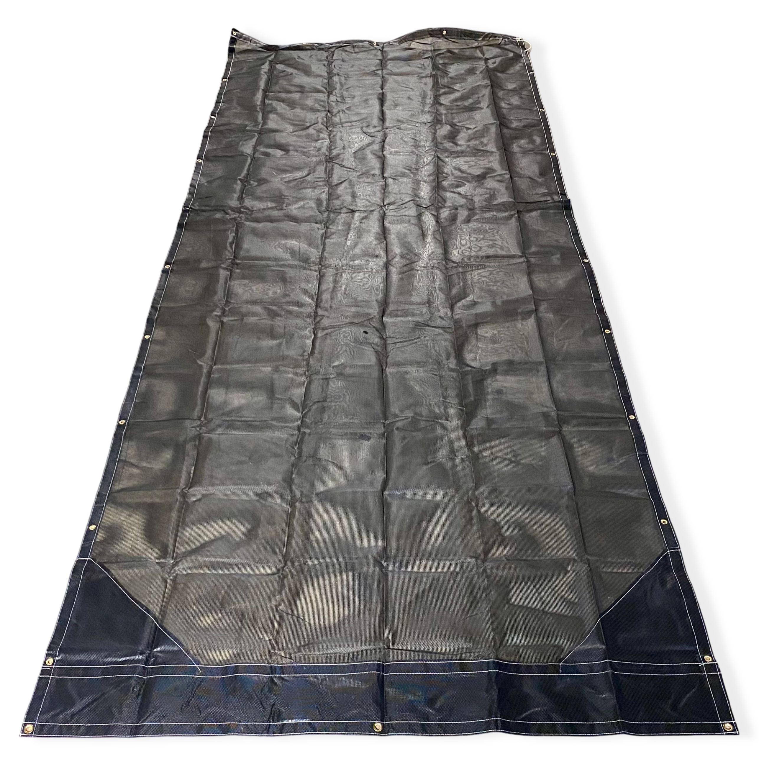 Top side of a black mesh tarp laid out on the floor showing the vinyl reinforced edges and even grommet spacing.
