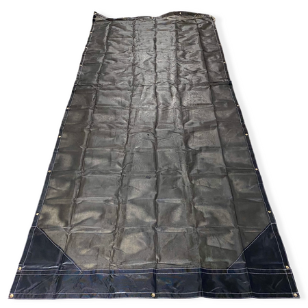 Top side of a black mesh tarp laid out on the floor showing the vinyl reinforced edges and even grommet spacing.